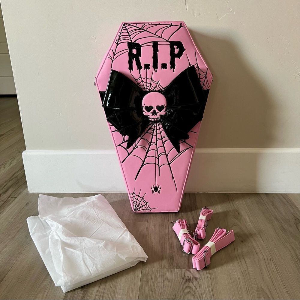 Dolls Kill oversize pink and black skull spiderweb coffin backpack. New in box